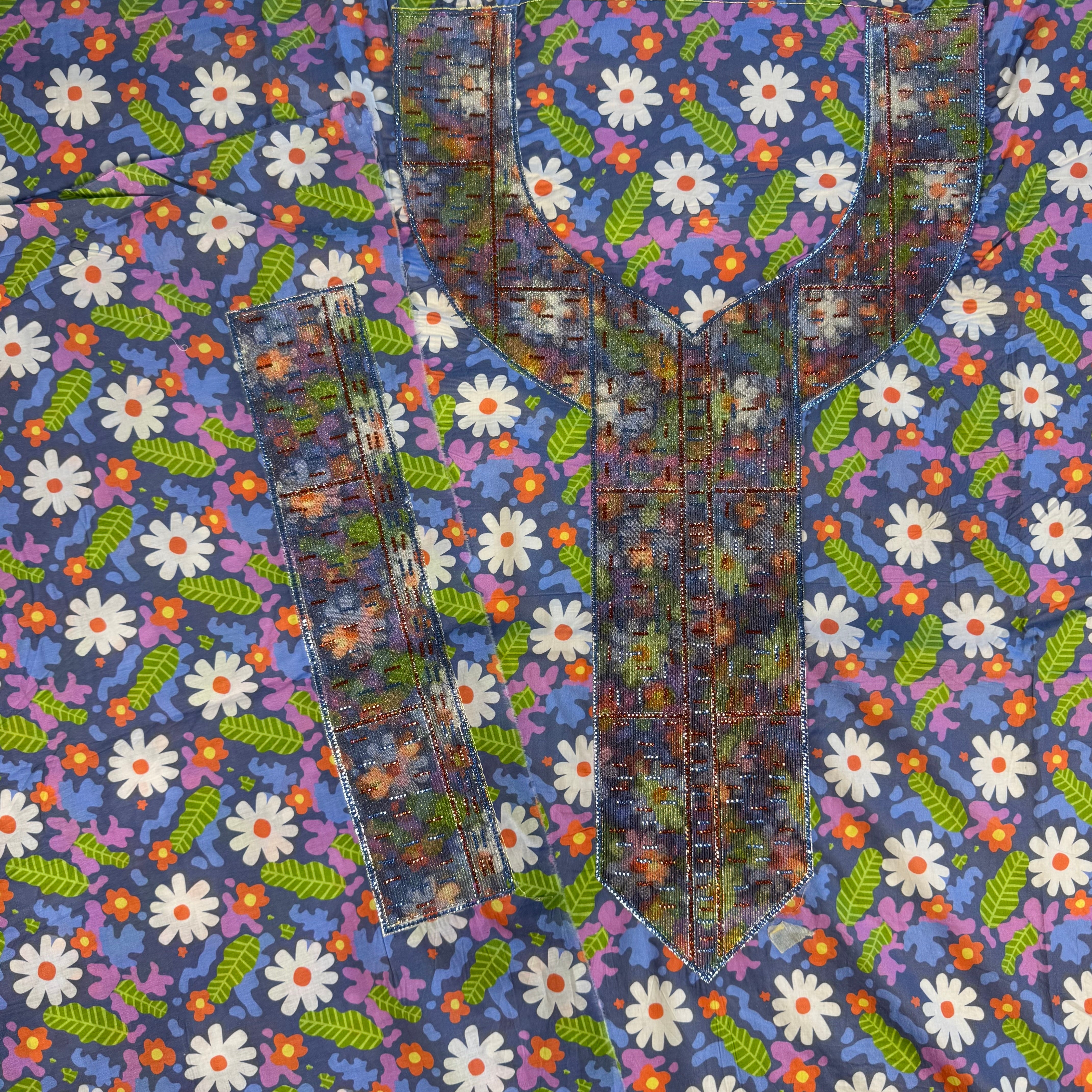 Embroidered dress with laser-cut embellishments and printed design